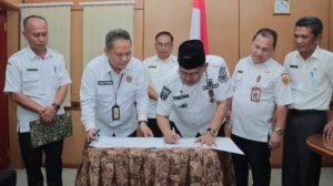 penandatanganan Nota Kesepakatan tentang pengintesifan pemungutan PBB Perdesaan dan Perkotaan (PBB-P2).(ist)