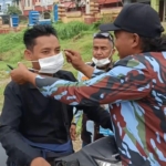 Kader DPP IPK Simalungun Memasangkan Masker ke pengendara.(Hegi)